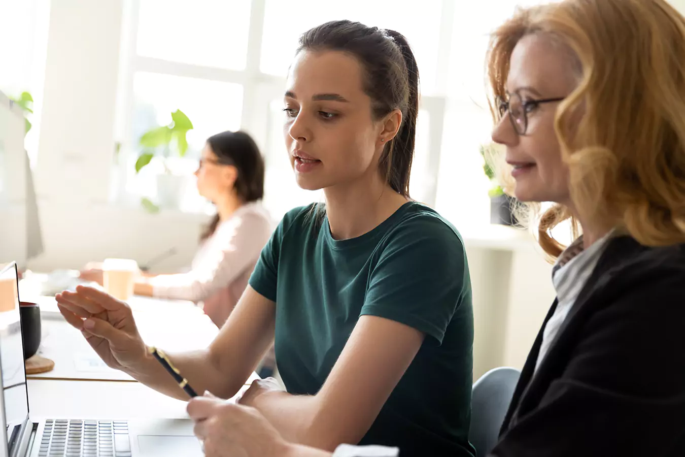 Two women looking at the laptop